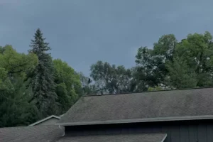 A building roof under cloudy sky.