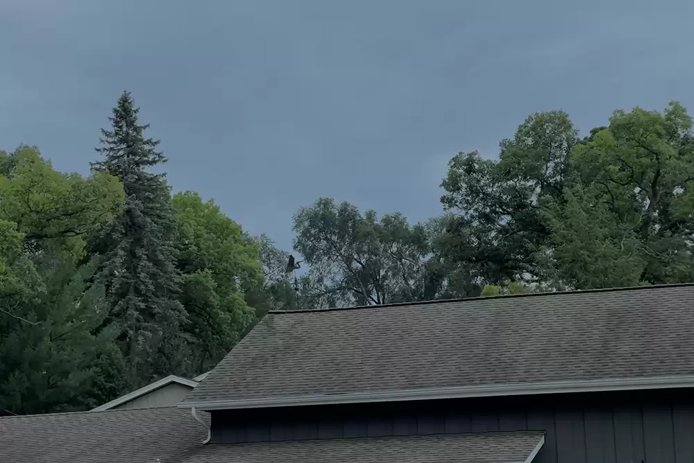 A building roof under cloudy sky.