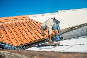 roofer man bent over working on roof