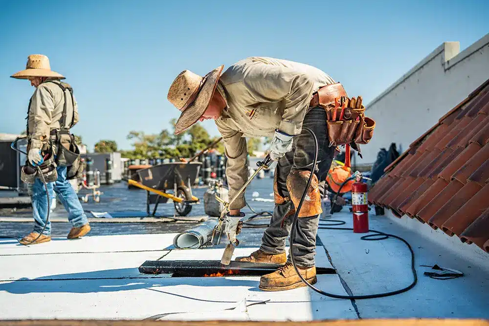 guys maintaining a commercial building roof