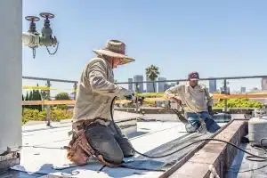 our technicians working on a commercial flat roof in Los Angeles
