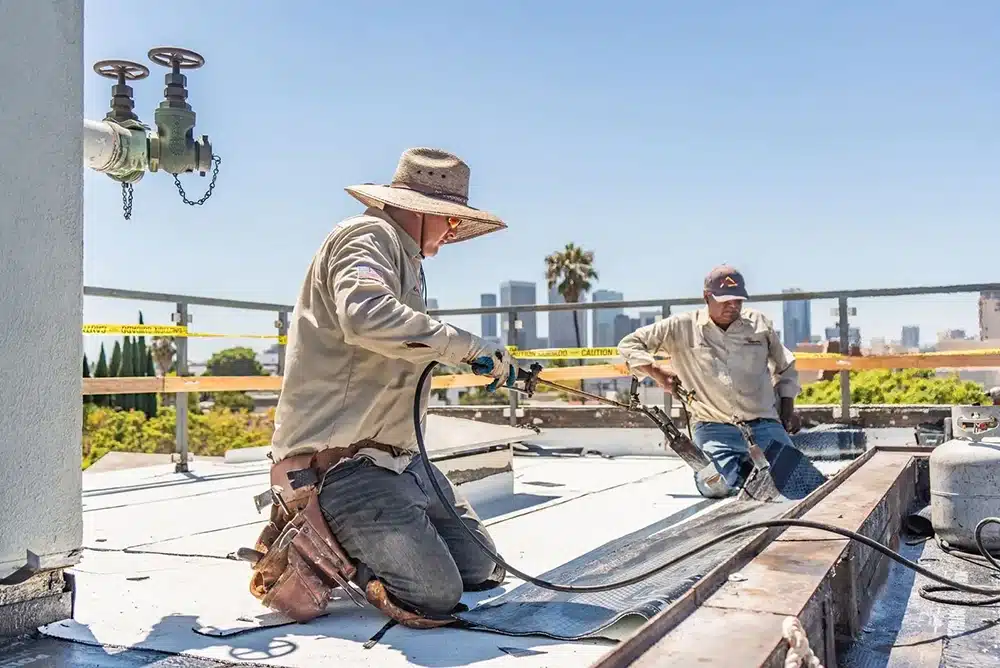 our technicians working on a commercial flat roof in Los Angeles