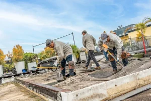 Three men on a roof.