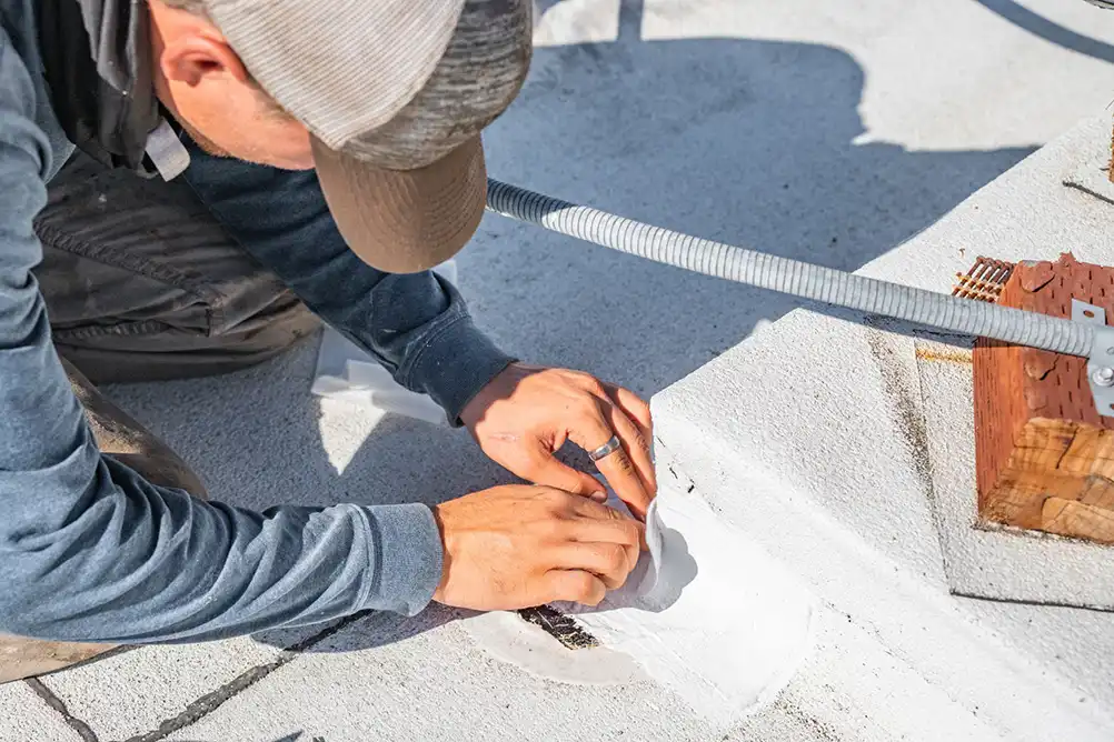 a roofing contractor repairing a roof leak