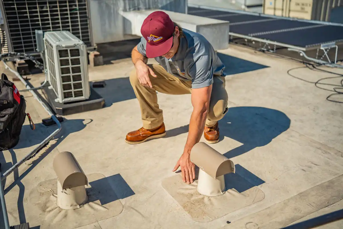 A roofing contractor performing a commercial roof inspection
