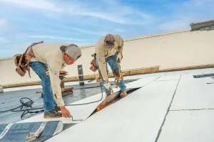 commercial roofing contractors installing a roof on a commercial building