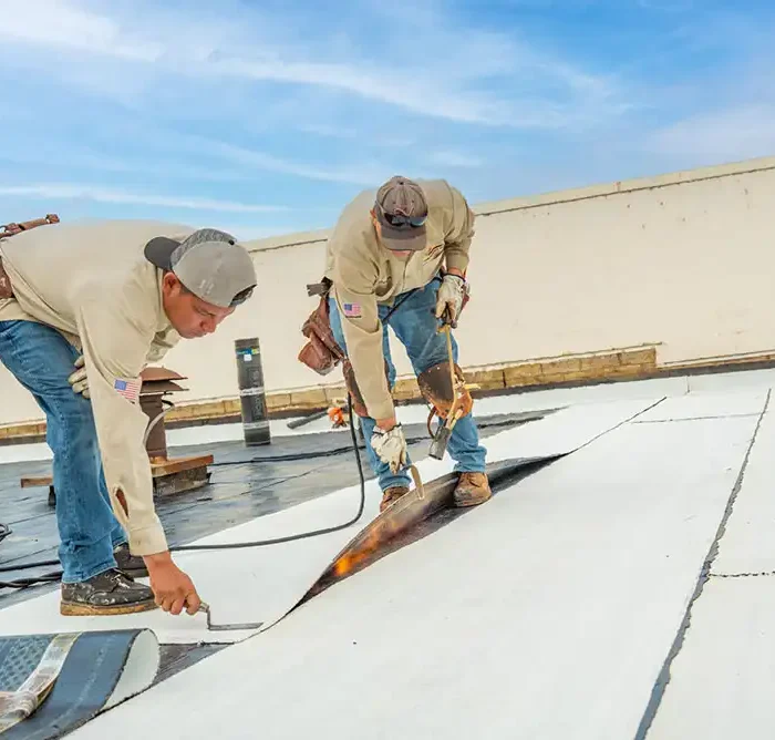 commercial roofing contractors installing a roof on a commercial building