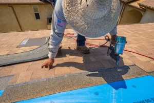A commercial roofing contractor replacing a roof.