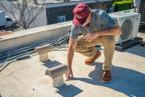 a commercial roofing contractor performing a maintenance inspection